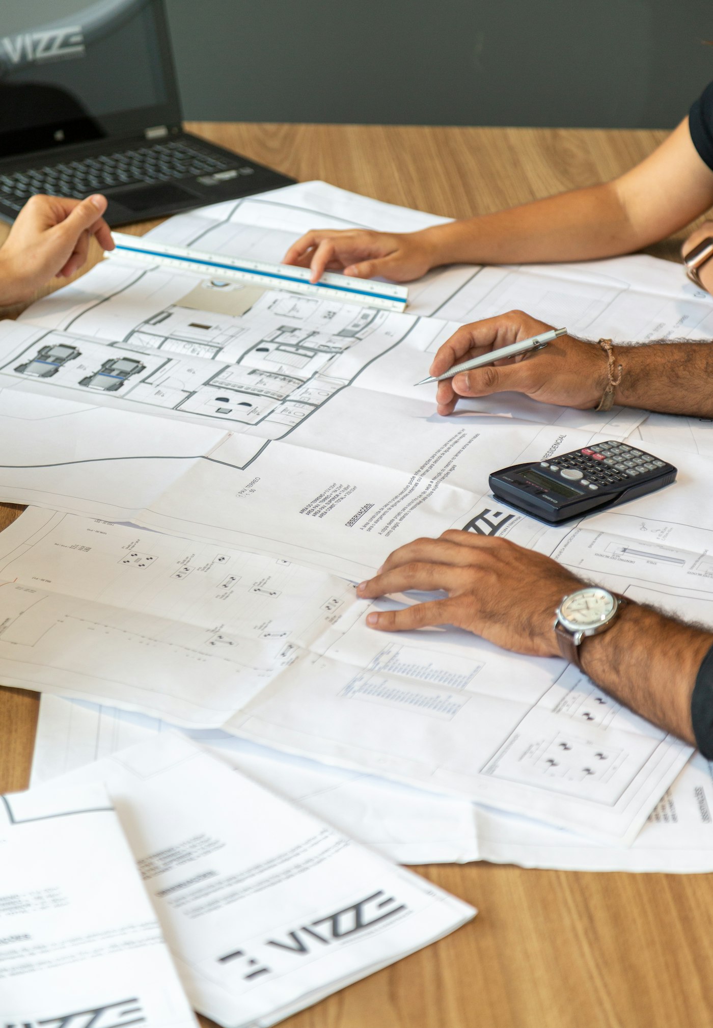Clients reviewing custom home plans with their builder