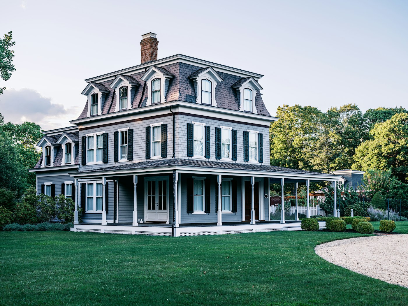 Restored Victorian home with wraparound porch near a town square