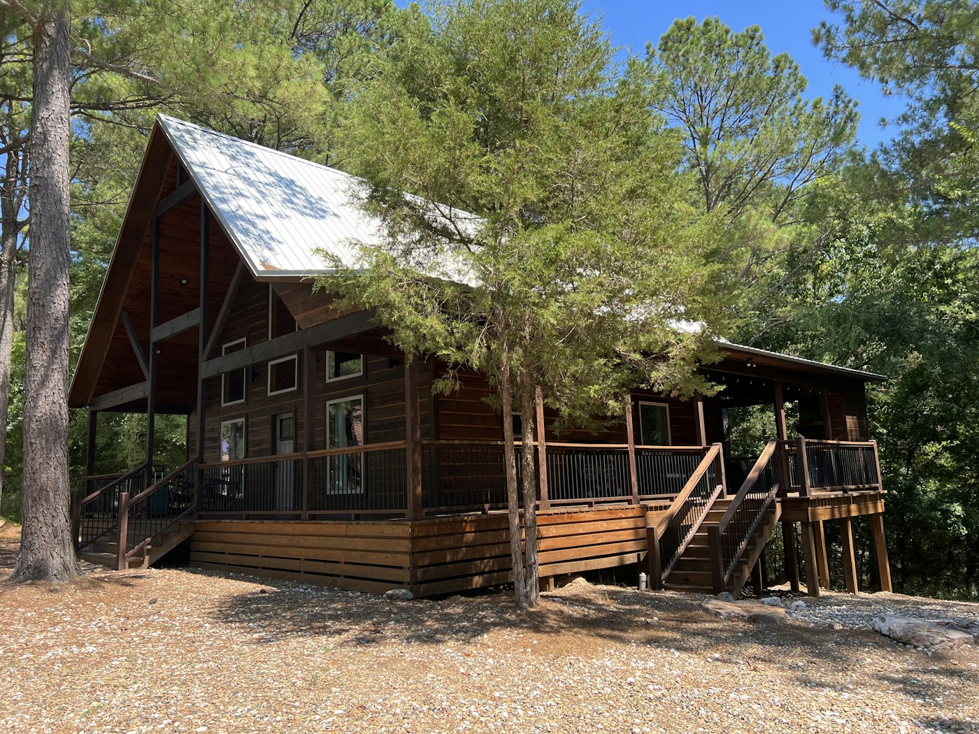 Newly constructed log cabin with front porch on rural acreage